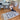 Amanda kloots and her sonis smiling and sitting on the floor on the unique bespoke hand made area rug in pure wool saying Live you life by Rich clas decor